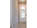 Bright foyer featuring tile flooring and a glass-paneled front door letting in natural light at 2285 Mystic Maze Ln, Clermont, FL 34715