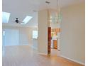 A bright, open floor plan connects the living room and kitchen with skylights and laminate floors at 2516 Albury Ave, Deltona, FL 32738