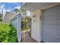 Private gated entrance with beautiful floral details and stylish number plaque at 264 Balfour Dr, Winter Park, FL 32792