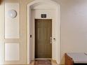 View of a well-lit front door with an electronic entry, a decorative welcome mat, and security features at 2781 Almaton Loop # 404, Kissimmee, FL 34747