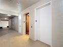Condo hallway featuring elevator and neutral decor, providing easy access to all units at 2781 Almaton Loop # 404, Kissimmee, FL 34747