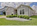View of the home's exterior featuring manicured landscaping and a manicured shrubbery at 299 Whirlaway Dr, Davenport, FL 33837