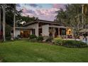 Lush backyard with a covered patio and landscaped garden providing a serene outdoor living space at 320 Mary Jess Rd, Orlando, FL 32839