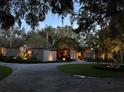 Stunning home exterior at twilight, featuring unique stone accents and professional landscape lighting at 320 Mary Jess Rd, Orlando, FL 32839
