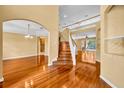 Open entryway boasts gleaming hardwood floors and a staircase to the second floor at 353 Meadow Beauty Ter, Sanford, FL 32771