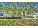 Home featuring a well-manicured lawn, lush landscaping, and a welcoming front entrance at 353 Meadow Beauty Ter, Sanford, FL 32771