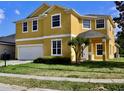 Charming two-story home featuring a well-maintained lawn, bright exterior paint and an attached two car garage at 369 James Cir, Lake Alfred, FL 33850