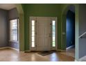 Bright foyer featuring tile floors, arched doorways, and neutral paint colors with large windows at 369 James Cir, Lake Alfred, FL 33850