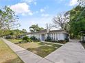 Inviting single-story home featuring a landscaped front yard and a paved driveway at 4025 Luan Dr, Orlando, FL 32808