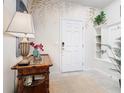 Inviting entryway showcasing a stylish console table, elegant decor, and a decorative accent wall at 4098 Lana Ave, Davenport, FL 33897