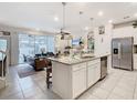 Open-concept kitchen boasts a granite island, stainless steel appliances, and seamless flow to the living area at 4098 Lana Ave, Davenport, FL 33897