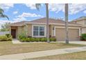 Inviting single-Gathering home with a two-car garage, beautiful landscaping, and a covered front entry at 427 Highland Meadows St, Davenport, FL 33837