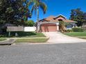 Well-maintained front yard with lush lawn, mature trees, and charming landscaping at 450 Morning Blossom Ln, Oviedo, FL 32765