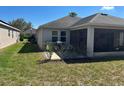 Outdoor kitchen area on a back porch overlooking a spacious yard at 457 Bridgeford Crossing Blvd, Davenport, FL 33837