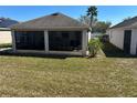 Spacious screened patio, perfect for outdoor living, with a lush green lawn at 457 Bridgeford Crossing Blvd, Davenport, FL 33837