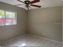 Bright bedroom featuring tile flooring and a ceiling fan at 4736 Southold St, Orlando, FL 32808