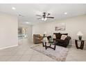 Bright living room featuring tile flooring, a ceiling fan, and a sliding glass door leading to the outdoors at 4800 Beacon St, Orlando, FL 32808