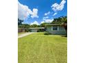 Ranch-style home with well-maintained lawn, simple landscaping, and a visible two-car garage at 532 Madison Ave, Orlando, FL 32805