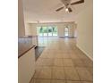 Open concept living and dining area with tiled floors, ceiling fans, and sliding glass doors to the backyard at 532 Madison Ave, Orlando, FL 32805