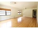 Large living room with hardwood flooring, ceiling fans, and window coverings adding to the living space's comfort at 532 Madison Ave, Orlando, FL 32805