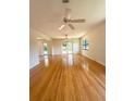 Open living area with lots of natural light, beautiful hardwood floors, and two ceiling fans at 532 Madison Ave, Orlando, FL 32805