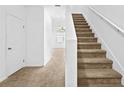 Bright hallway with carpeted stairs leading up to the next level at 597 Madison Dr, Davenport, FL 33837
