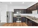 Modern kitchen with stainless steel appliances and granite countertops at 597 Madison Dr, Davenport, FL 33837