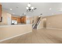 Inviting living space showcasing an open layout, tile floors, and staircase to the upper level at 9469 Edenshire Cir, Orlando, FL 32836