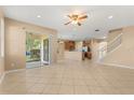 Bright and airy living room featuring tile flooring and a view of the outdoor living space at 9469 Edenshire Cir, Orlando, FL 32836
