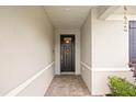 Inviting front entry features a decorative black door with a transom window and sidelight at 951 Cutke Rd, St Cloud, FL 34771