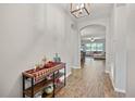 Welcoming hallway showcases tile flooring and an arched entryway to a living space at 951 Cutke Rd, St Cloud, FL 34771