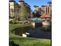 Exterior view of community pool and grounds featuring gazebo, lounge chairs and condo buildings at 12539 Floridays Resort Dr 411 # 411D, Orlando, FL 32821