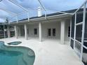 Expansive covered patio area adjacent to a screened-in pool, ideal for outdoor gatherings at 2600 Cedar Bluff Ln, Ocoee, FL 34761