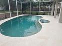 Beautiful screened-in pool with an attached spa and ample deck space for lounging at 2600 Cedar Bluff Ln, Ocoee, FL 34761