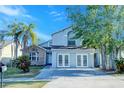 Charming two-story home with brick and siding exterior, well-manicured landscaping and inviting curb appeal at 8812 Kensington Ct, Kissimmee, FL 34747