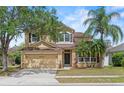 Charming two-story home with a well-maintained lawn, mature trees, and inviting curb appeal at 108 Portstewart Dr, Orlando, FL 32828