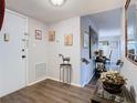 Inviting hallway boasts wood-look floors, neutral paint, artwork, and seamless flow into the living space at 200 Maitland Ave # 87, Altamonte Springs, FL 32701