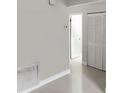 The bright hallway features white tile floors and white closets at 2832 Risser Ave, Orlando, FL 32812