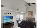 The living room has high ceilings, a brick fireplace, tile floors, and a ceiling fan at 2832 Risser Ave, Orlando, FL 32812