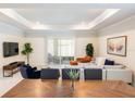 Spacious living room with large windows, modern decor, and comfortable seating at 4012 Meandering Bay Dr, Apopka, FL 32712