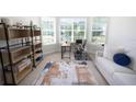 Bright living room showcasing a comfortable couch, modern shelving, and large windows at 4012 Meandering Bay Dr, Apopka, FL 32712