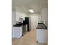 Functional kitchen featuring stainless steel appliances, white cabinets, and durable countertops at 479 Little Aspen Ct, Ocoee, FL 34761