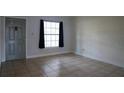 Living room with tile flooring, large window, and neutral paint at 479 Little Aspen Ct, Ocoee, FL 34761