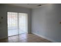 Living room with tile flooring and sliding doors to the screened porch at 479 Little Aspen Ct, Ocoee, FL 34761
