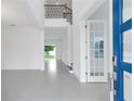 Bright foyer featuring an open floor plan, tile flooring, high ceilings, and modern finishes at 10013 Brocksport Cir, Gotha, FL 34734