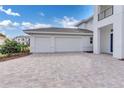 Spacious three-car garage with a paved driveway and manicured landscaping, offering both convenience and curb appeal at 10013 Brocksport Cir, Gotha, FL 34734