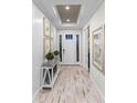 Inviting foyer with light wood floors, recessed lighting, and a view of the front door at 1062 Lakeside Estates Dr, Apopka, FL 32703