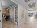 Bright hallway showcasing the beautiful floors, tray ceilings, and access to various rooms at 1062 Lakeside Estates Dr, Apopka, FL 32703