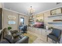 Stylish home office with custom built-ins, decorative lighting, and a comfortable seating area at 1062 Lakeside Estates Dr, Apopka, FL 32703