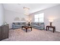 Bright living room featuring two comfortable sofas, and elegant chandelier fixture at 1092 Sugarwood St, Davenport, FL 33837